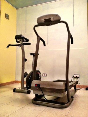 a gym with a treadmill and a exercise bike at Hotel Letizia in Orte