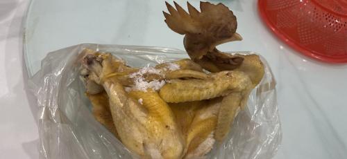 a plastic bag of food with a bird on top of it at Hoa Mai Hotel in Trạm Chánh An