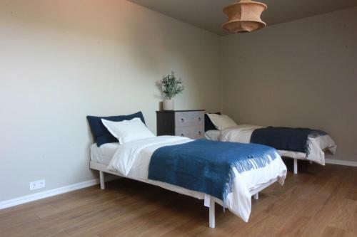 a bedroom with two beds and a couch and a fan at Spacious apartment in the country side in Vellinge