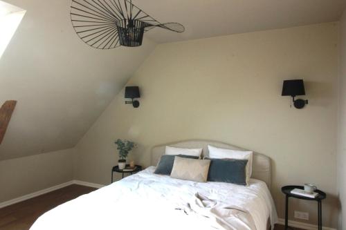 a bedroom with a white bed with two night stands at Spacious apartment in the country side in Vellinge