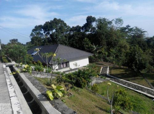 a house with a garden in front of it at Fafa Hill Hotel and Resort in Bogor