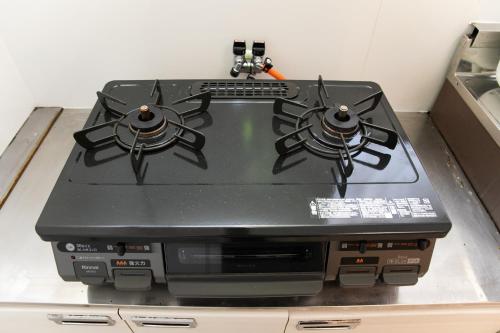 a stove top oven sitting on top of a counter at Miraie Kuwana Shimofukayabe 2 in Kuwana