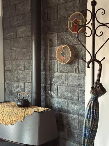 a brick wall with a fireplace with a vase on a table at Hamsa Suite in Mas'ade