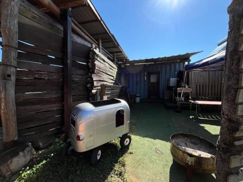 a small trailer is parked next to a building at あさひシーサイドコテージ in Asahi