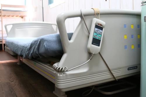 a hospital bed with a cell phone in it at あさひシーサイドコテージ in Asahi