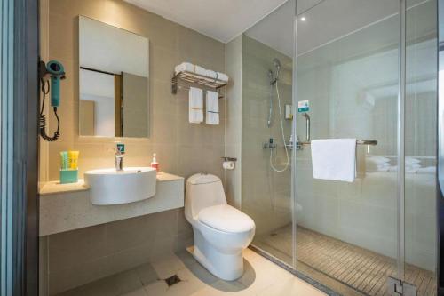 a bathroom with a toilet and a sink and a shower at City Comfort Inn Dangtu High Speed East Railway Station RT-Mart in Ma'anshan