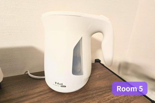 a white appliance sitting on top of a wooden table at Vacation House 2 in Funabashi