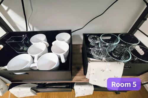 a box filled with cups and saucers on a table at Vacation House 2 in Funabashi