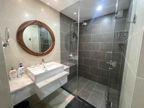 a bathroom with a sink and a mirror at Grands StarCity in Nha Trang