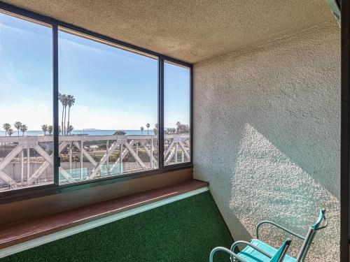 a room with a balcony with a view of the ocean at Amanzi Hotel, an Ascend Collection Hotel in Ventura