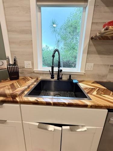 a kitchen counter with a sink and a window at A-Treat-Retreat with AC,Laundry,Patio in Captain Cook