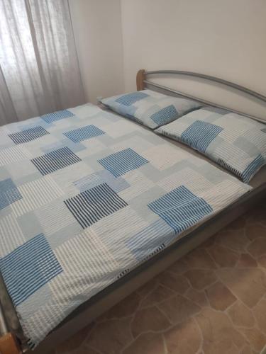 a bed with blue and white sheets on it at Nový kemp Slezské Pavlovice in Slezské Pavlovice
