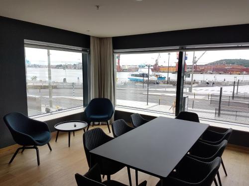 a meeting room with a table and chairs and windows at Comfort Hotel Göteborg in Gothenburg