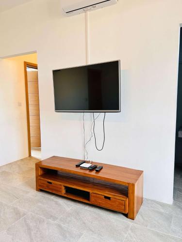a flat screen tv hanging on a white wall at Luxurious 3 Bedroom Villa with Private Pool - NG1 in Arsenal