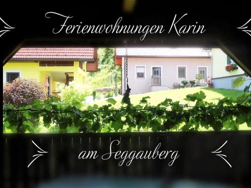 a view of a house from a window with a plant at Ferienwohnungen Karin am Seggauberg in Leibnitz