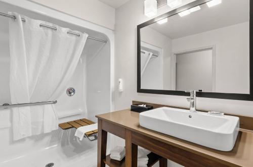 a white bathroom with a sink and a mirror at Country Inn & Suites by Radisson, Roanoke, VA in Roanoke