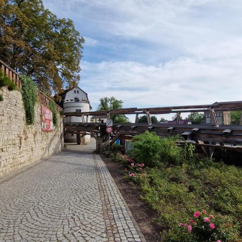 a bridge with a lighthouse in the background and flowers at Ferienwohnung "Kleine Auszeit" in Bad Kösen