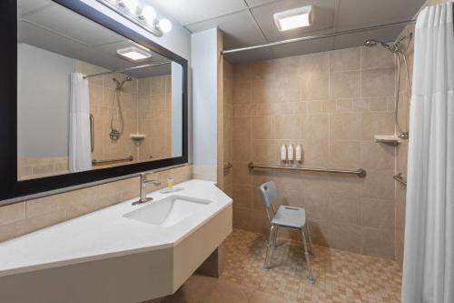 a bathroom with a sink and a shower at Super 8 by Wyndham Traverse City in Traverse City