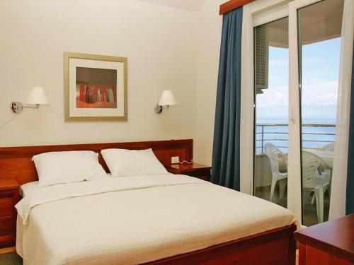 a bedroom with a bed and a balcony at Apartment in Veli Losinj by the Sea in Veli Lošinj