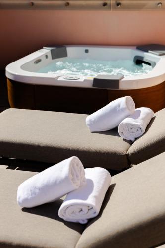 three massage chairs with a spa tub in the background at FH55 Grand Hotel Palatino in Rome