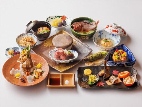 a group of plates of food on a table at Unzen Kanko Hotel in Unzen
