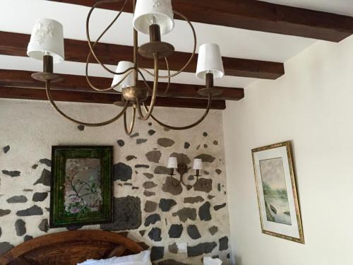 a chandelier hanging from a ceiling in a bedroom at L'ESCALE DE CAMILLE in Murat