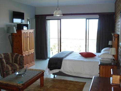 a hotel room with a bed and a large window at W21 in Great Brak River