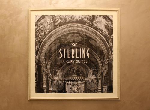 a picture of a theater in a frame on a wall at Sterling Luxury Suites Valletta in Valletta