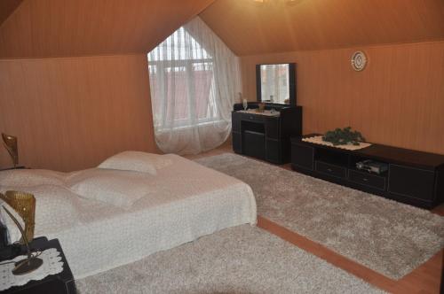 a bedroom with a bed and a sink and a mirror at Raduga 514 in Zatoka