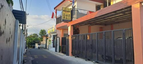 a building with a fence on the side of a street at Bintang Khanida Syari'ah in Tjakranegara