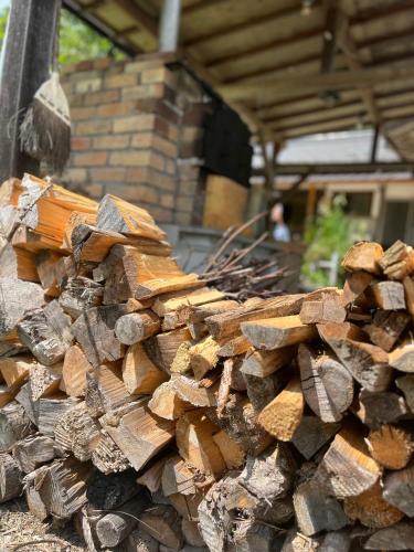 a pile of fire wood in front of a building at Vacation Rental あんばええ in Nakatsugawa