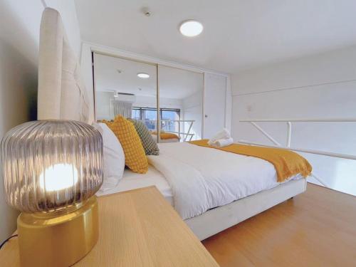 a bedroom with a bed with a large mirror at Super Darling Harbour View in Sydney
