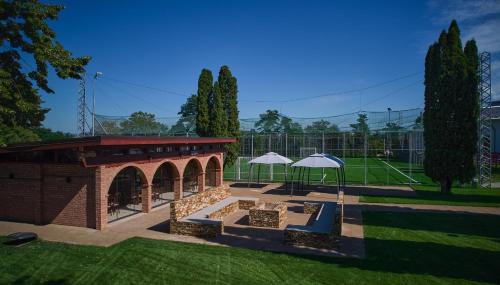 a pavilion with two white umbrellas in a park at Conacul Domnesc in Suceava