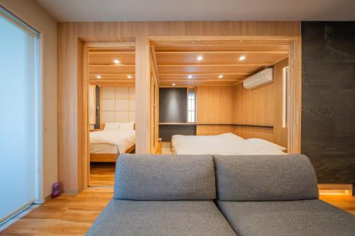 a living room with a couch and a bedroom at winco - Vacation STAY 06660v in Tokyo