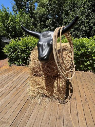 a statue of a cow on a pile of hay at Bluebird Cottage in West Tamworth