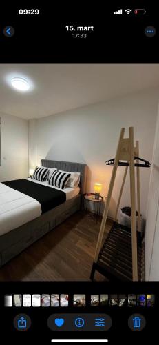 a picture of a bedroom with a bed and a ladder at Apartman Idila in Ruma