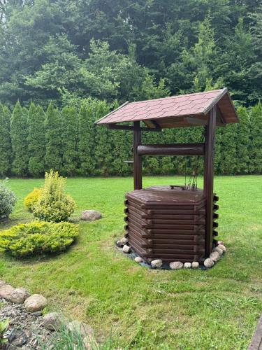 a gazebo sitting in the middle of a yard at Domek pod lasem in Kańczuga
