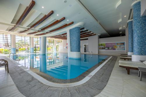 a large swimming pool in a building with blue tiles at VONRESORT Elite & Aqua - Ultra All Inclusive & Kids Concept in Side