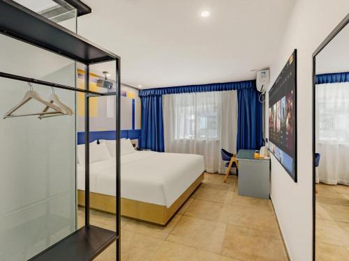 Ένα ή περισσότερα κρεβάτια σε δωμάτιο στο 7 Days Inn Nanchang Shuanggang Metro Station Jiangxi University of Finance and Economics 2nd Branch