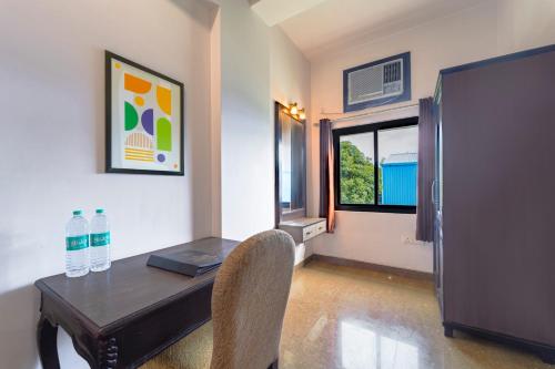 a dining room with a table with a laptop on it at Treebo Shivam Inn Near Singapore Mall in Lucknow
