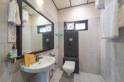 a bathroom with a sink and a toilet at Treebo Shivam Inn Near Singapore Mall in Lucknow