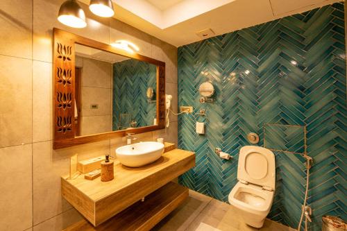 a bathroom with a sink and a toilet at GANGA KINARE- A Riverside Boutique Resort, Rishikesh in Rishīkesh
