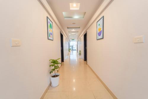 a corridor of an office building with plants on the walls at Treebo Shivam Inn Near Singapore Mall in Lucknow