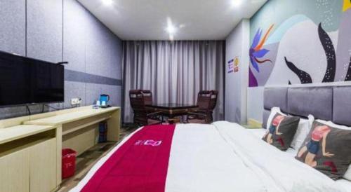a hotel room with a large bed and a flat screen tv at Pai Hotel Xi'an Electronic Zheng Street in Xi'an