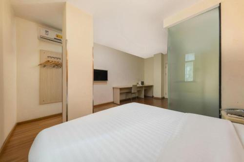 Katil atau katil-katil dalam bilik di 7 Days Inn Dongguan Changping Railway Station