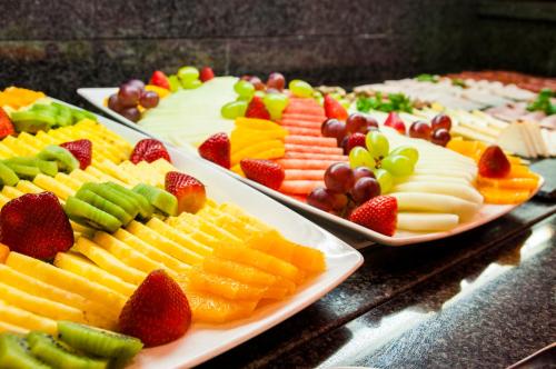 a table with three plates of different types of fruit at Eurostars Cristal Palace in Barcelona