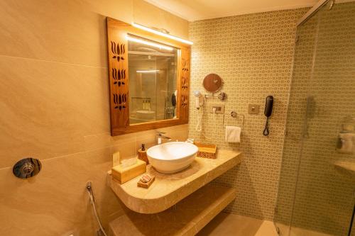 a bathroom with a sink and a shower at GANGA KINARE- A Riverside Boutique Resort, Rishikesh in Rishīkesh