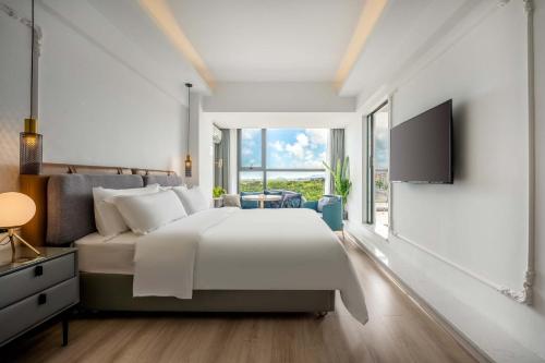 Letto o letti in una camera di Min Xiangmi Design Residence (Sanya Bay Phoenix International Airport Store)