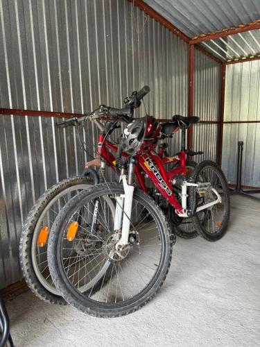 two bikes are parked in a garage at Domek pod lasem in Kańczuga