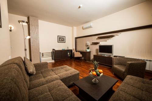 a living room with a couch and a television at Passage Hotel in Baku